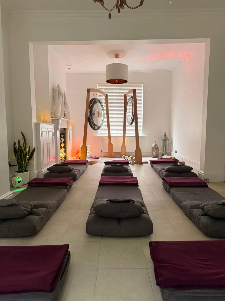 room with mats on floor, and 2 gongs